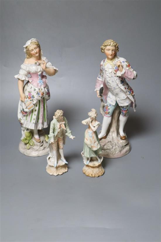 Two pairs of Continental porcelain figures of a man and woman, 15cm and 26cm